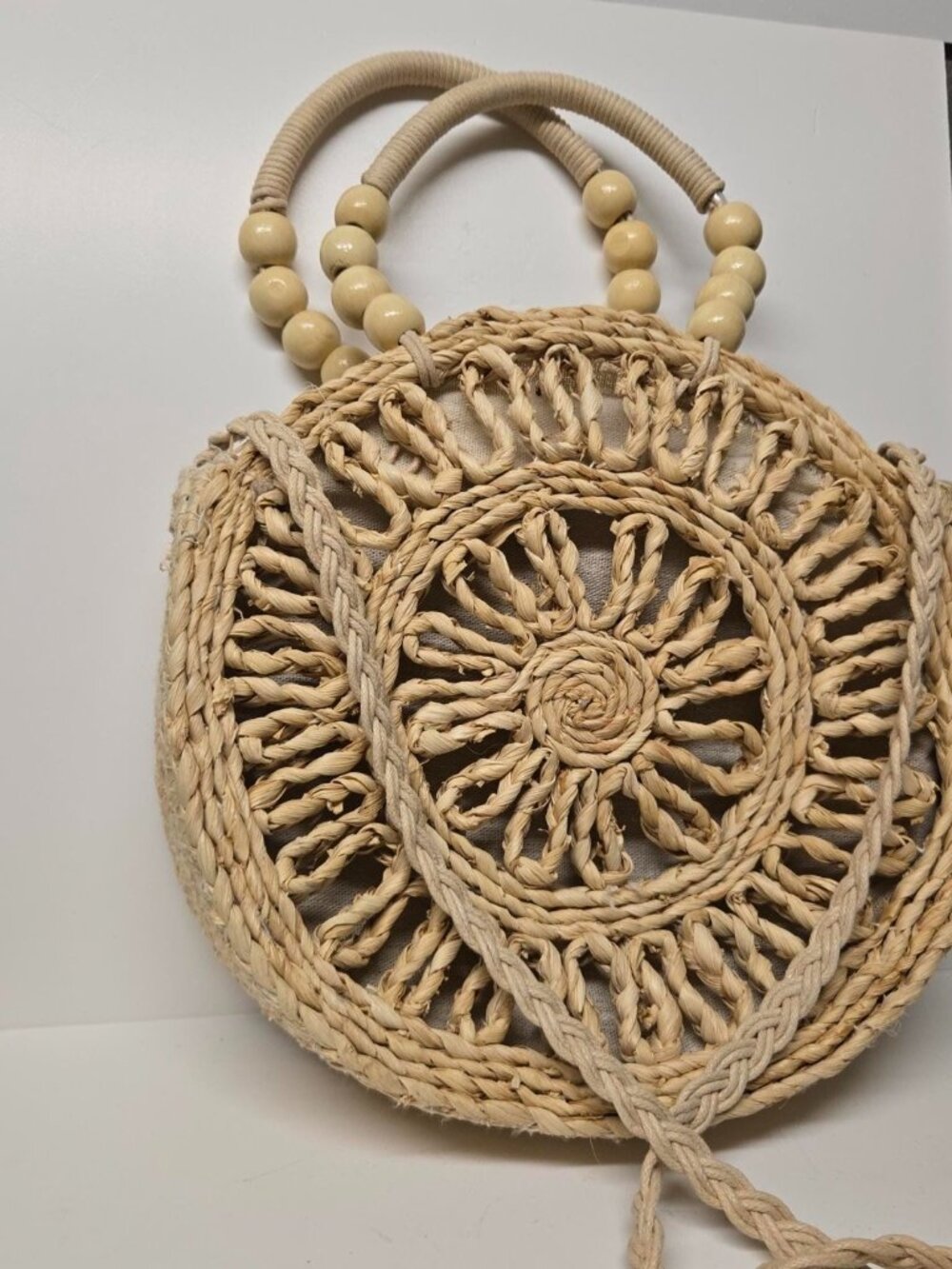 Bohemian SunNSand round natural fiber handbag with beaded handle and long braide